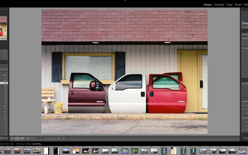 Lightroom classic with a picture of car doors leaning against a building in the edit window