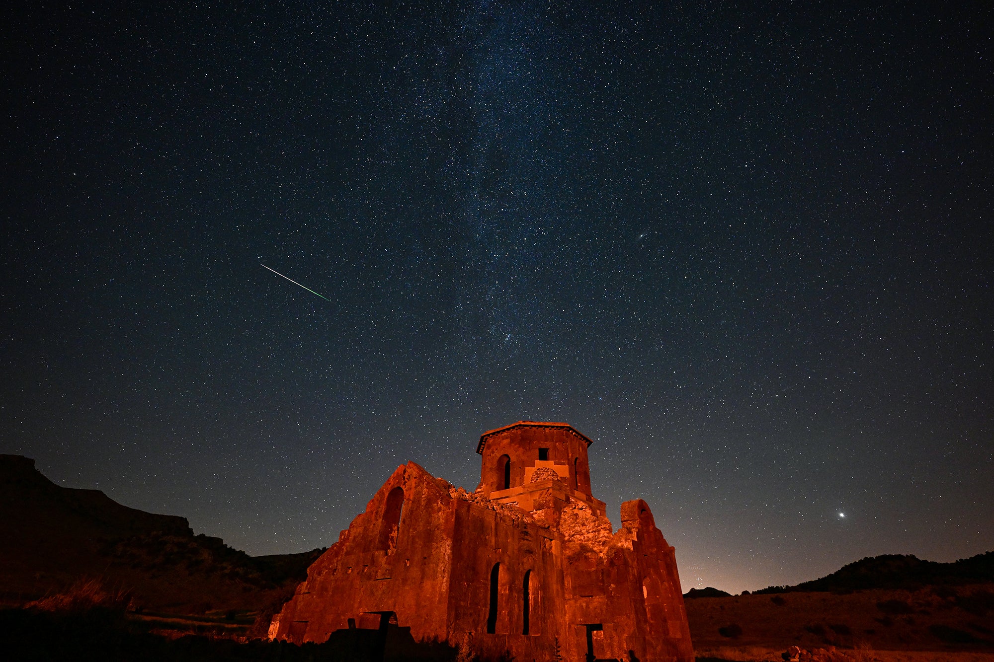 AKSARAY, TURKIYE - AUGUST 12: Perseid meteor shower is observed over Red Church and Guzelyurt Monastery Valley in Guzelyurt district of Aksaray, Turkiye on August 12, 2023. (Photo by Aytug Can Sencar/Anadolu Agency via Getty Images)