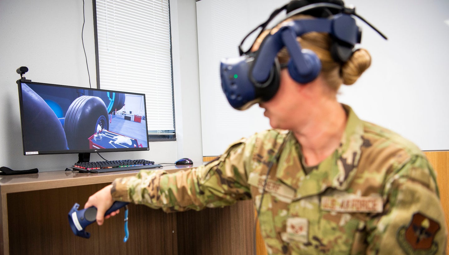 a member of the air force staff demonstrates a virtual reality training system.