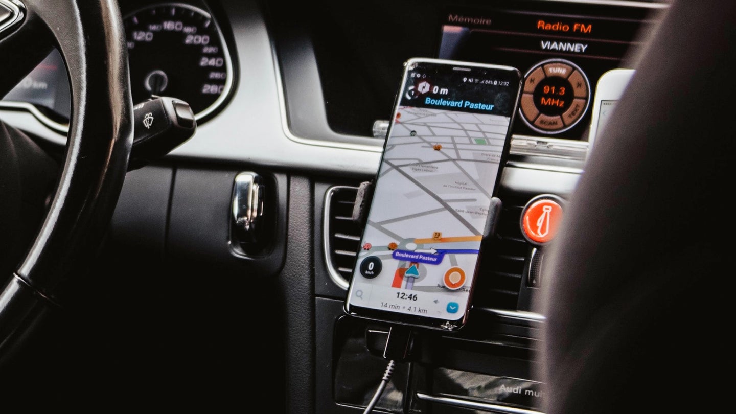 Phone showing Waze directions, probably using recorded voices for navigation