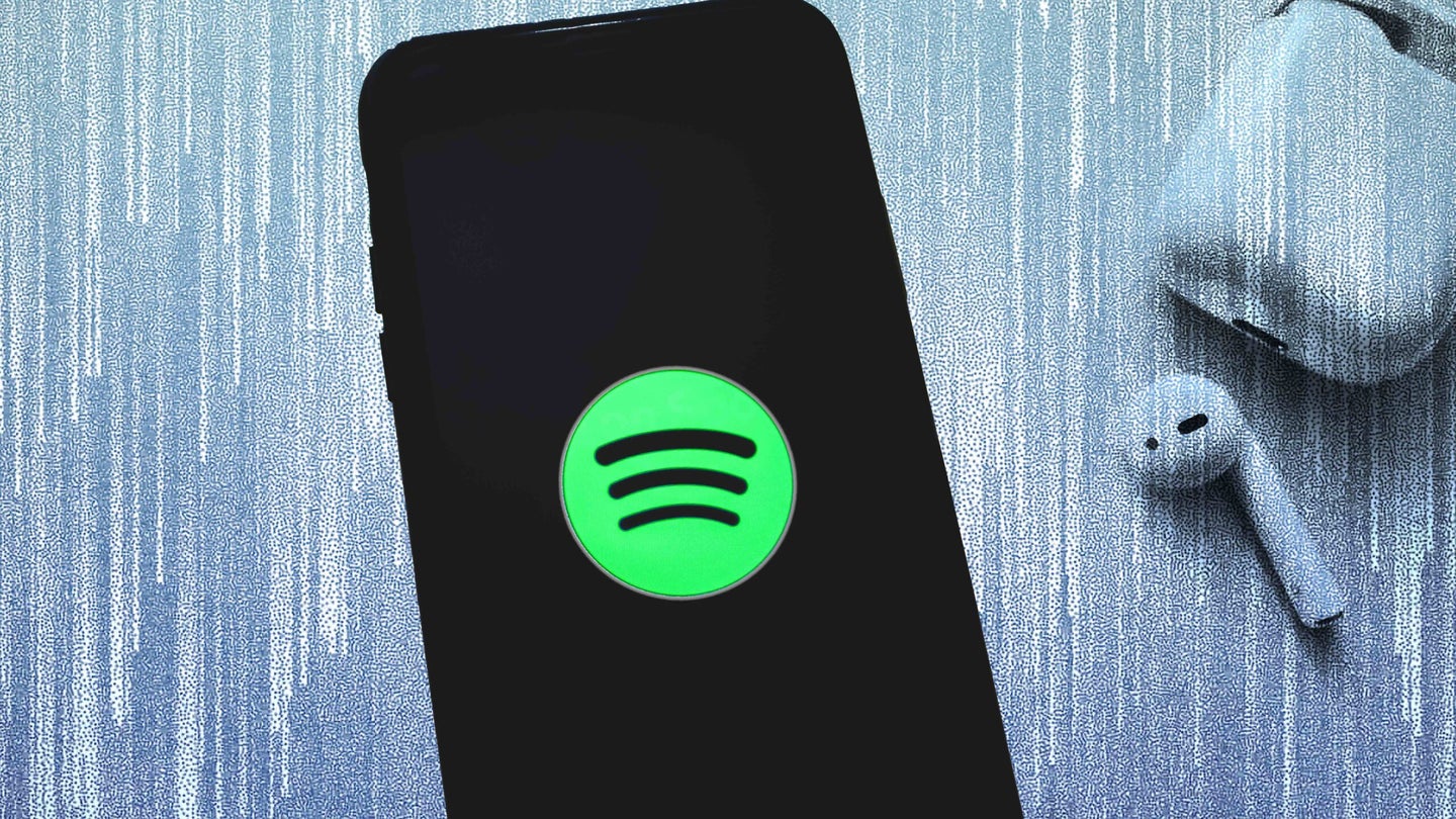 Spotify logo on smartphone next to AirPods