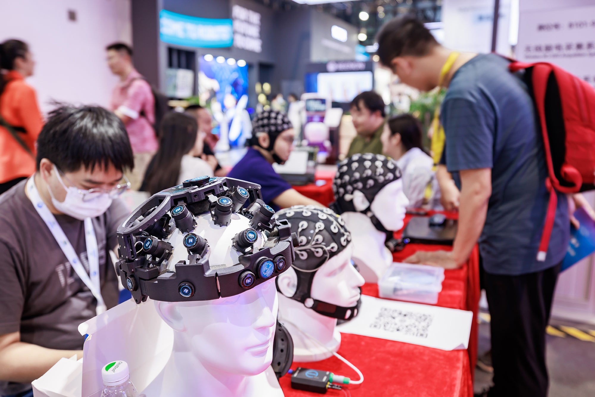 BEIJING, CHINA - AUGUST 19: People visit brain-computer interface (BCI) exhibition area during 2023 World Robot Conference at Beijing Etrong International Exhibition &amp; Convention Center on August 19, 2023 in Beijing, China. (Photo by Zhan Min/VCG via Getty Images)