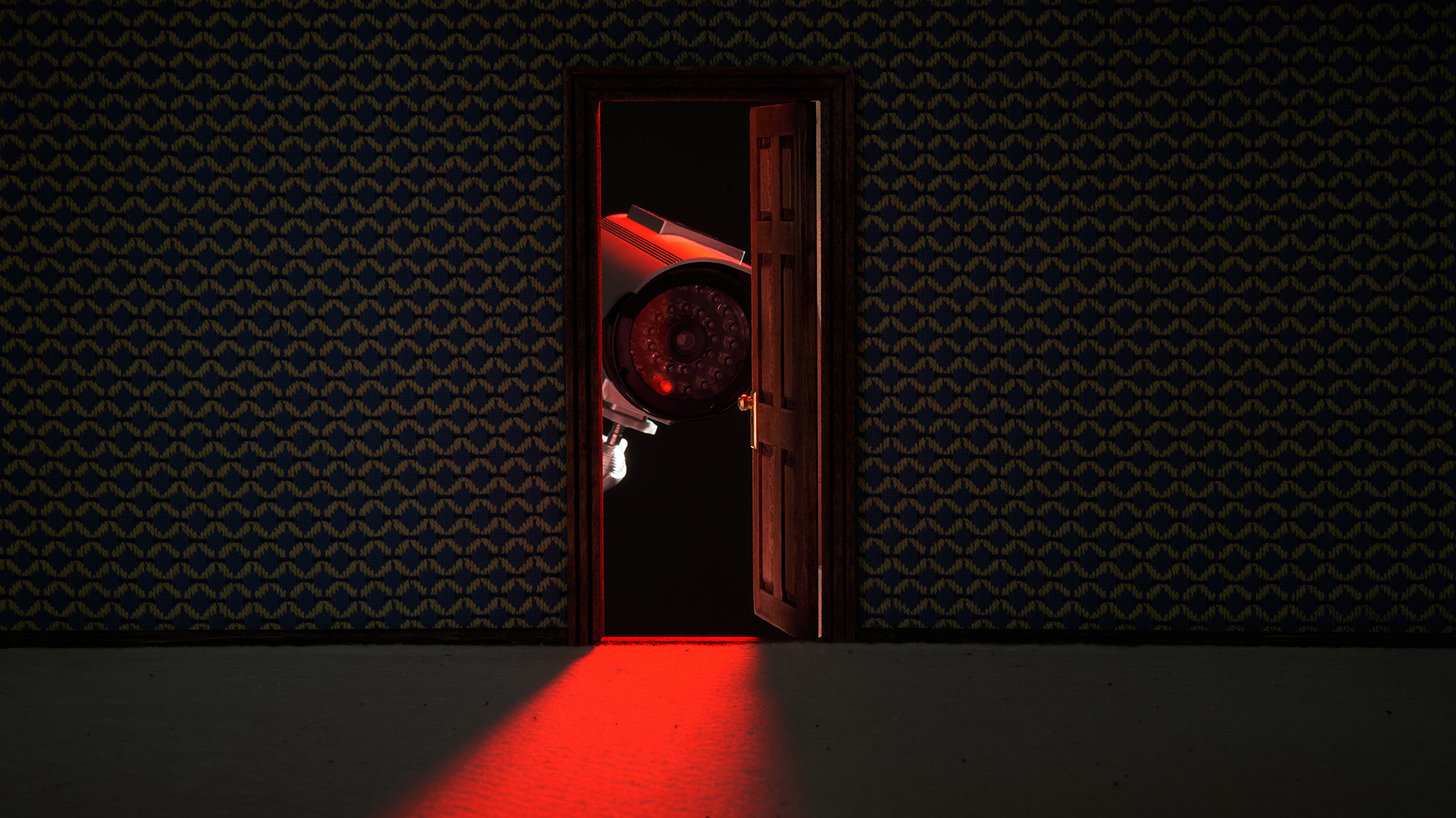 A security camera peeking through an open door.
