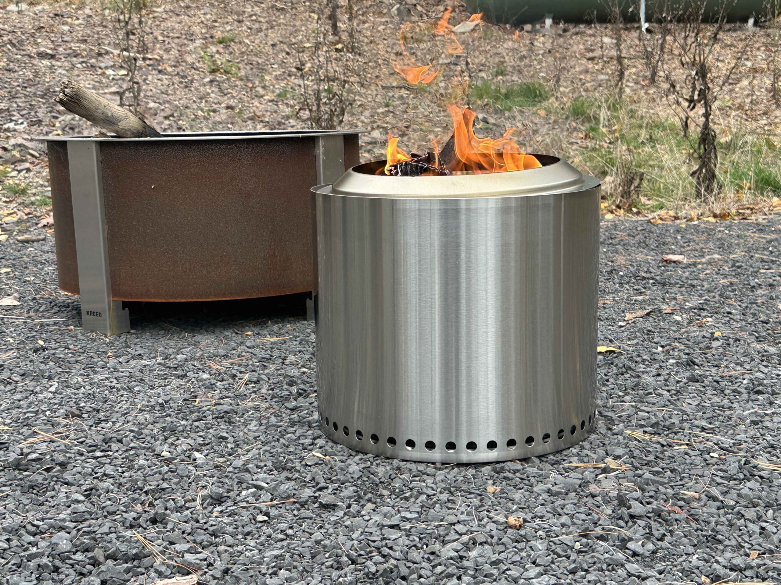 The Solo Stove Ranger 2.0 fire pit with a fire on gravel