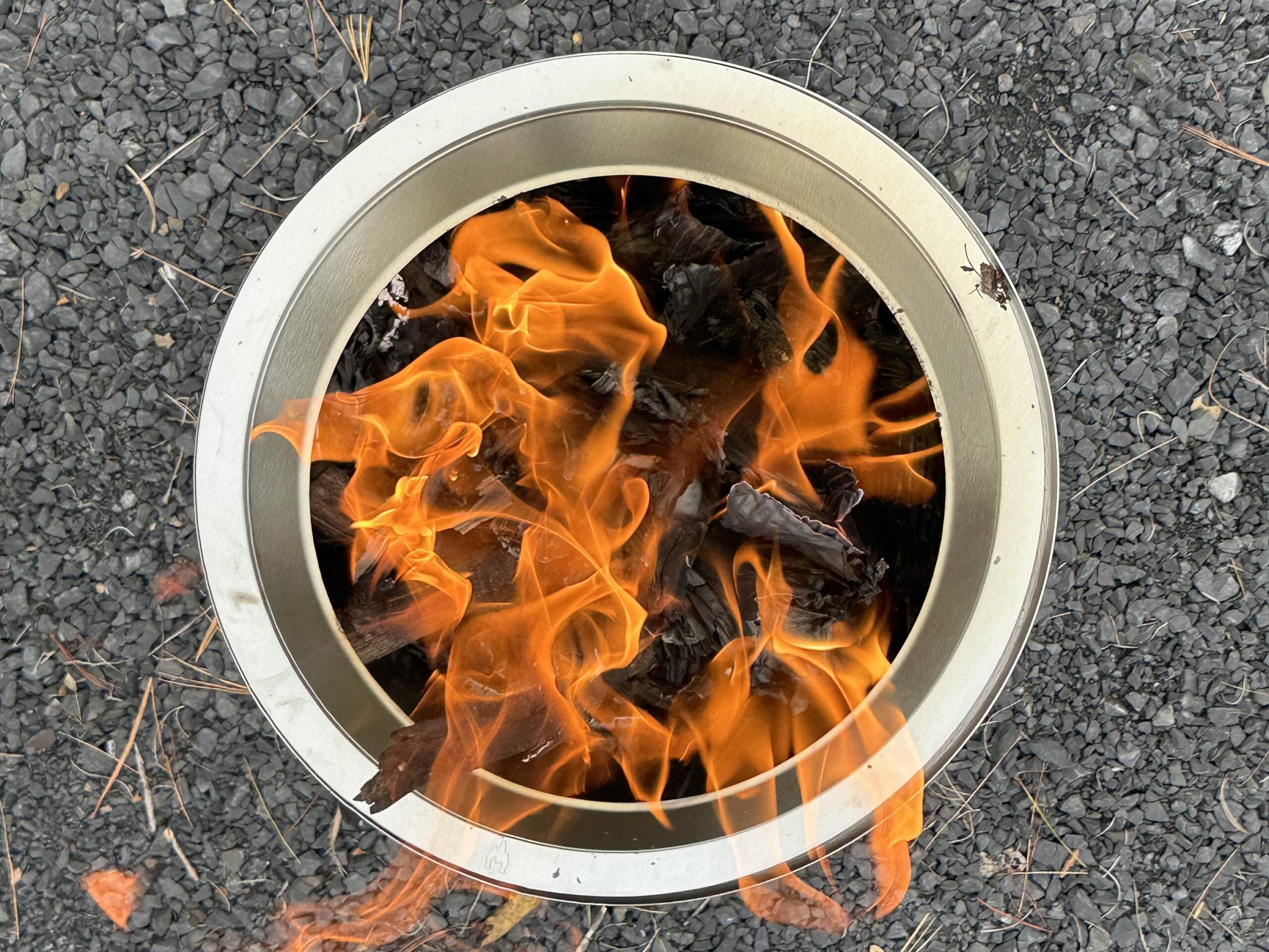 The Solo Stove Ranger 2.0 fire pit with a fire going inside