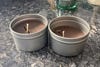 Two DIY citronella candles that have cracked due to quick cooling.
