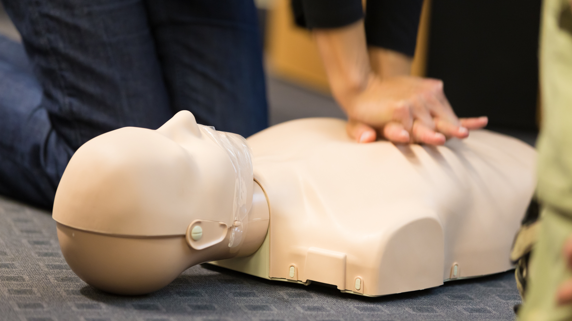 Hands giving CPR to mannequin