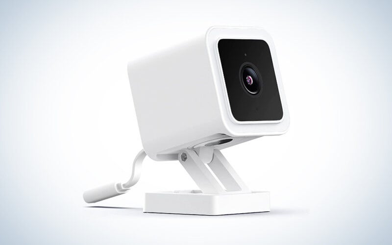 A Wyze Cam v3 outdoor security camera on a blue and white background