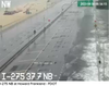 A traffic camera photograph of I-275 in Tampa, showing water coming over a barrier and onto the street. 