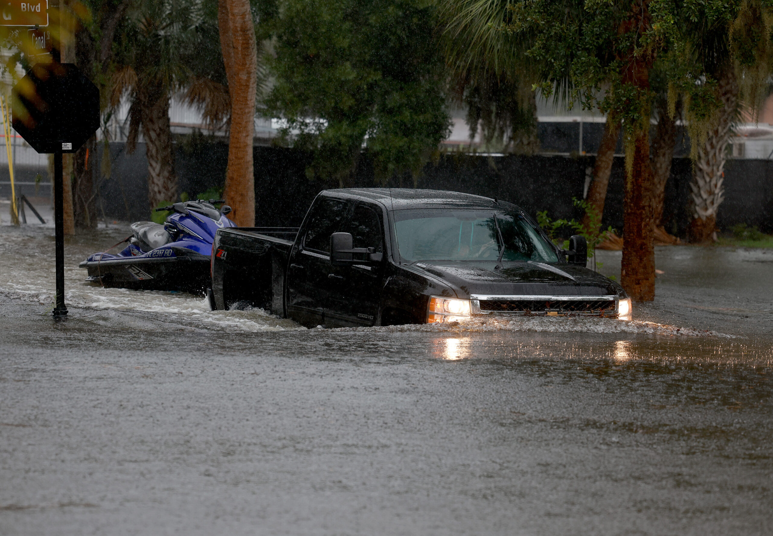 A truck passes through flooded streets caused by Hurricane Idalia passing offshore on August 30, 2023 in Tarpon Springs, Florida.
