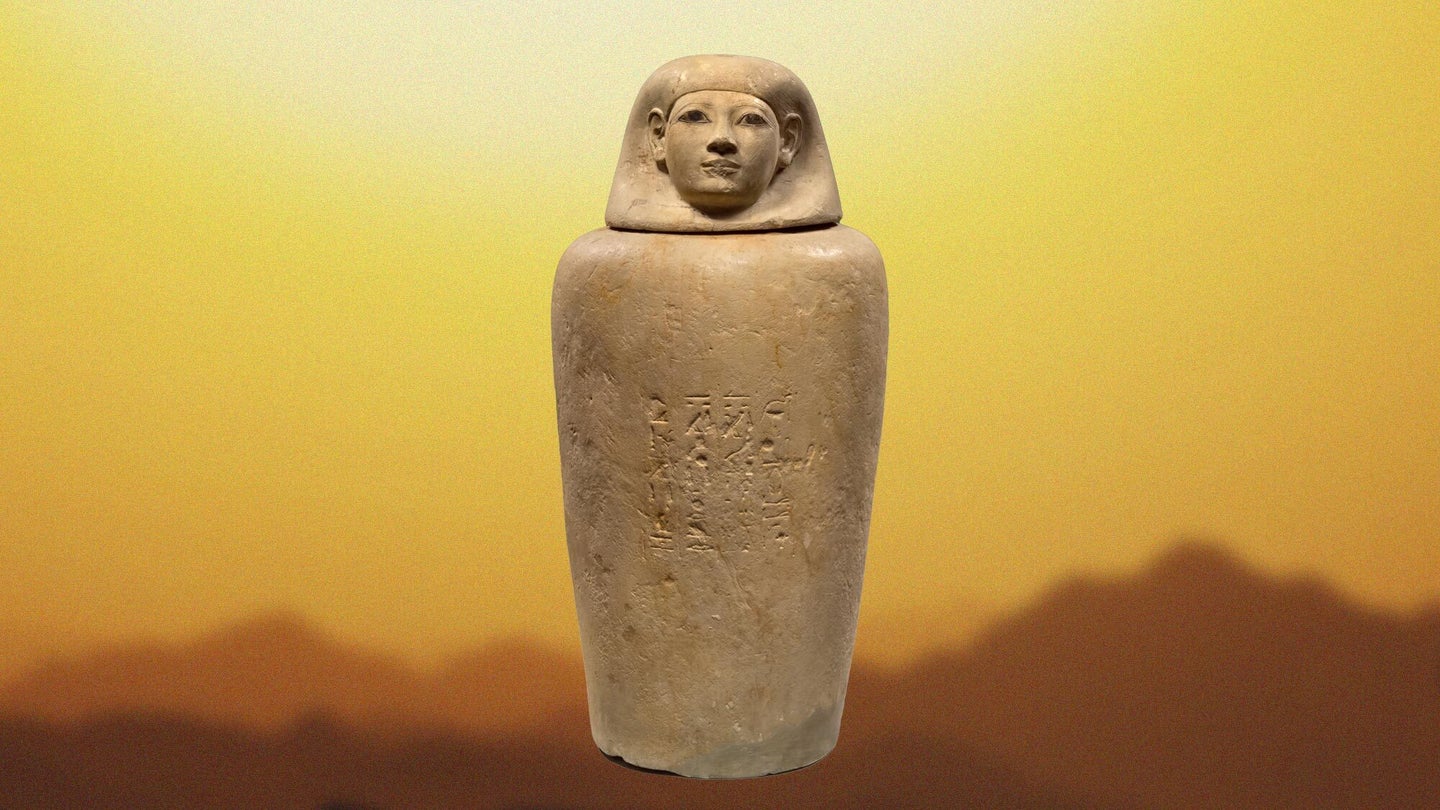 A stone jar against a yellow and orange desert background.