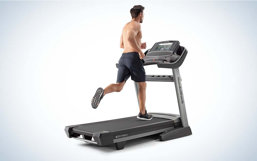 Picture of a shirtless man in shorts running on a treadmill.