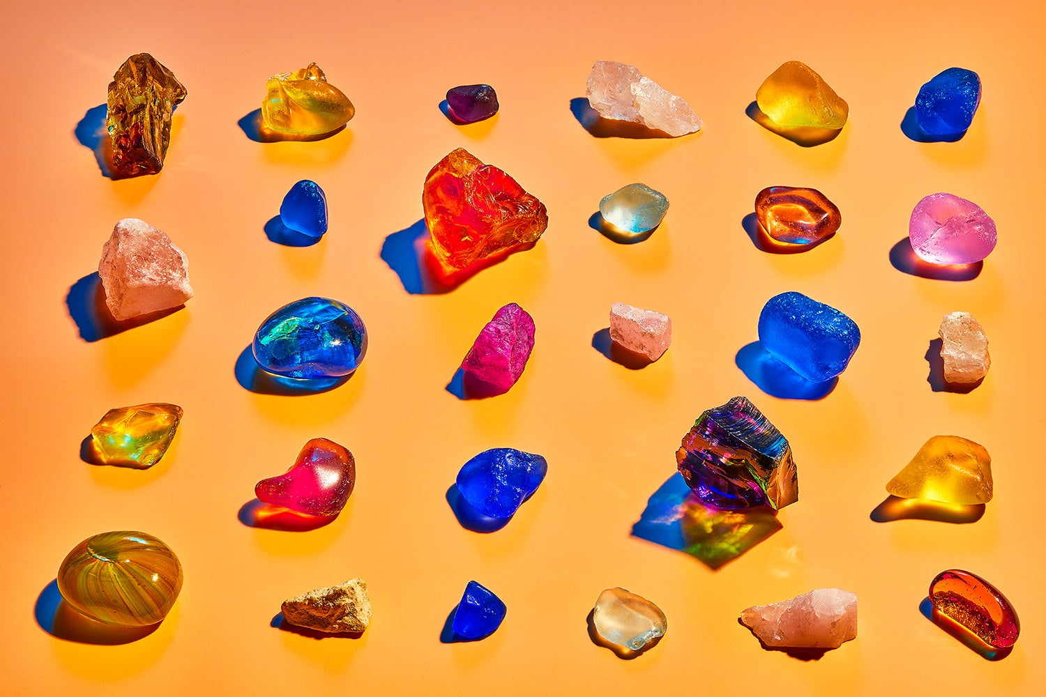 neatly arranged rows of colorful items purporting to be crystals