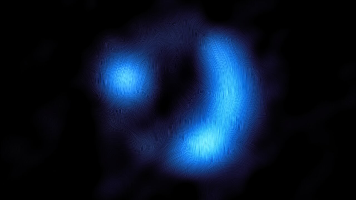A blue semi circle on the right with a ball of blue light on the left on a black background. The orientation of the magnetic field in the distant 9io9 galaxy, seen here when the universe was only 20 percent of its current age and the furthest ever detection of a galaxy’s magnetic field.
