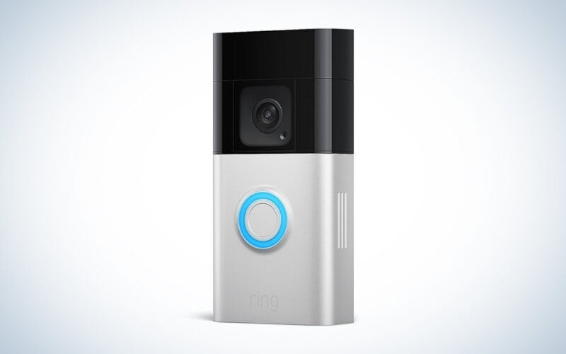 A Ring Battery Doorbell Plus on a blue and white bakground