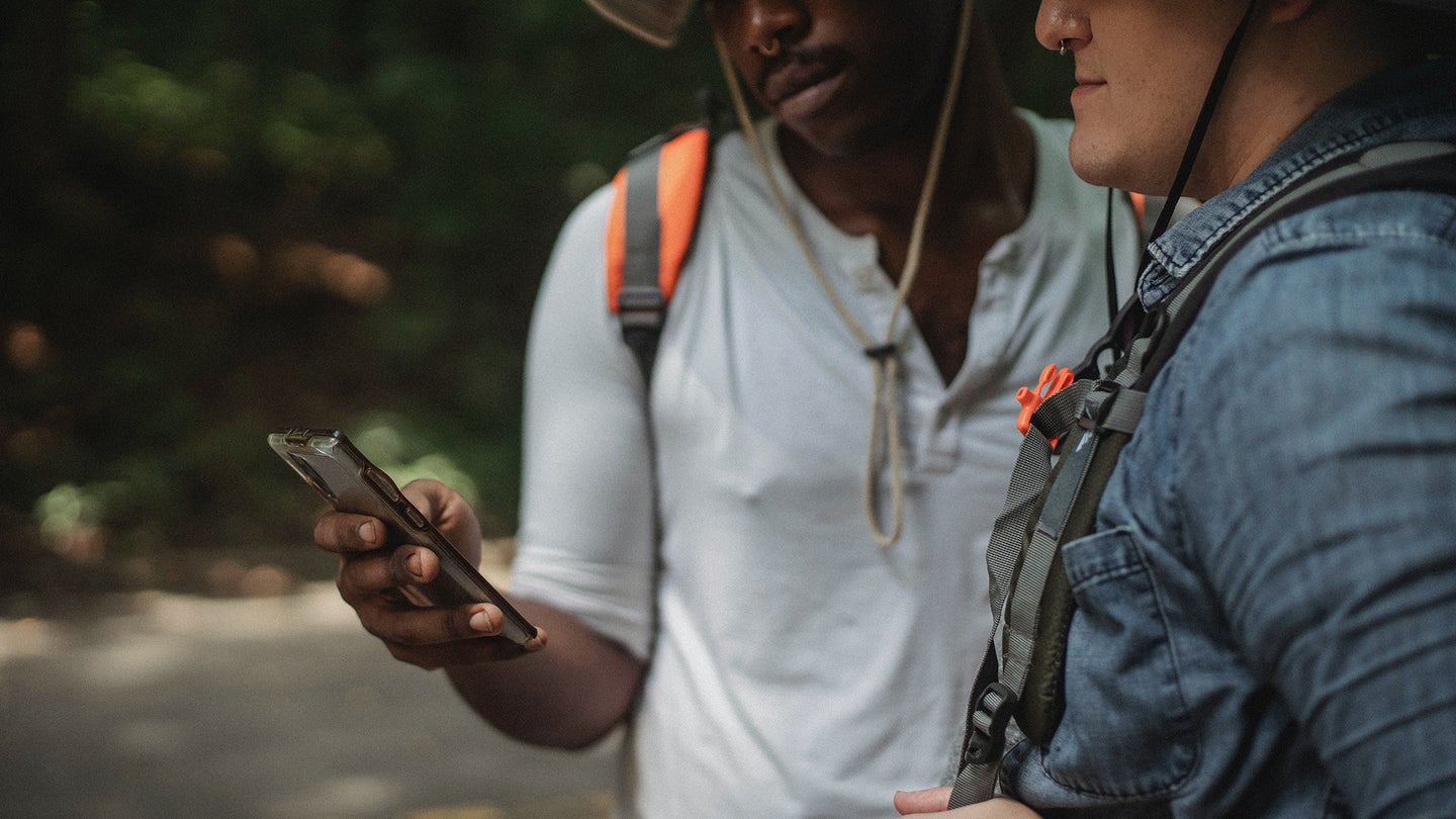 Two people using Apple Maps while hiking