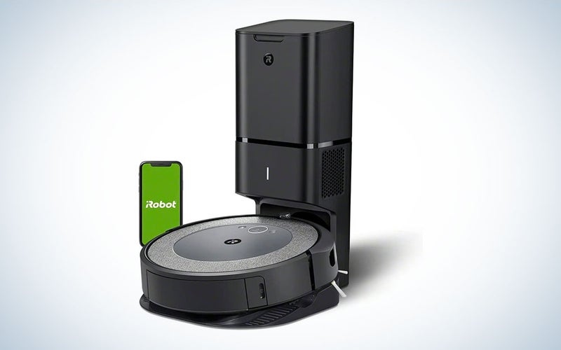A black iRobot Roomba i3+ EVO (3550) Self-Emptying Robot Vacuum on a blue and white background