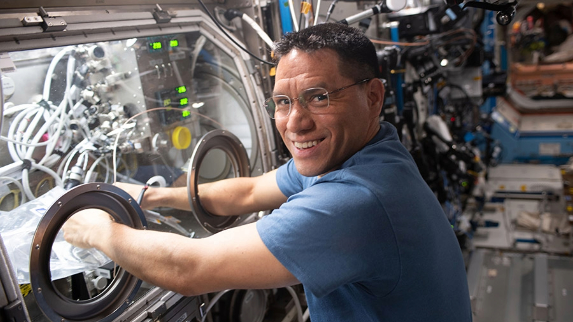 Astronaut Frank Rubio works in the Microgravity Science Glovebox swapping graphene aerogel samples for a space manufacturing study.