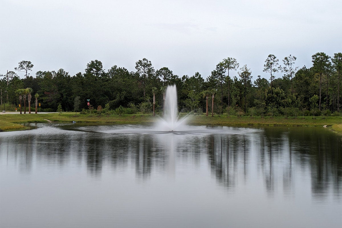 A photo of a water fountain in a small pond