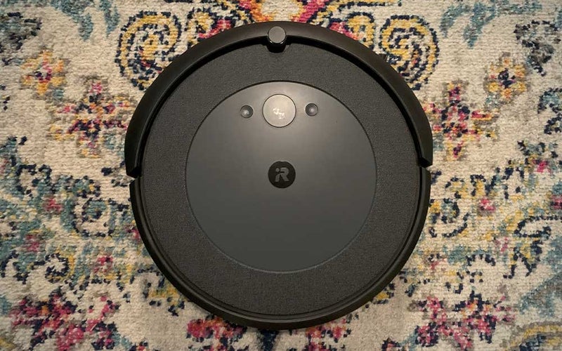 A round iRobot Roombas i4 on Jen's colorful rug