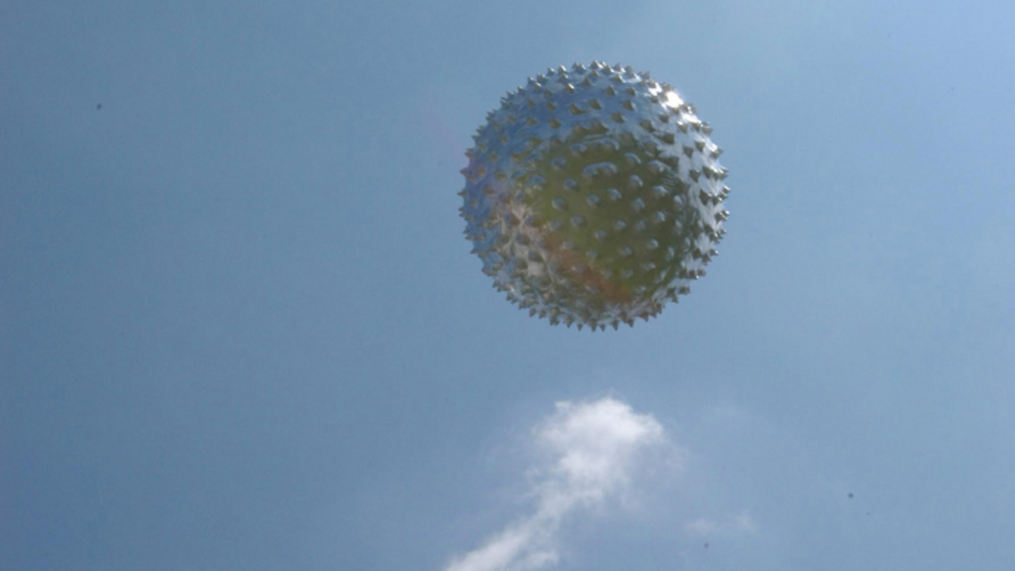A weather balloon against blue sky