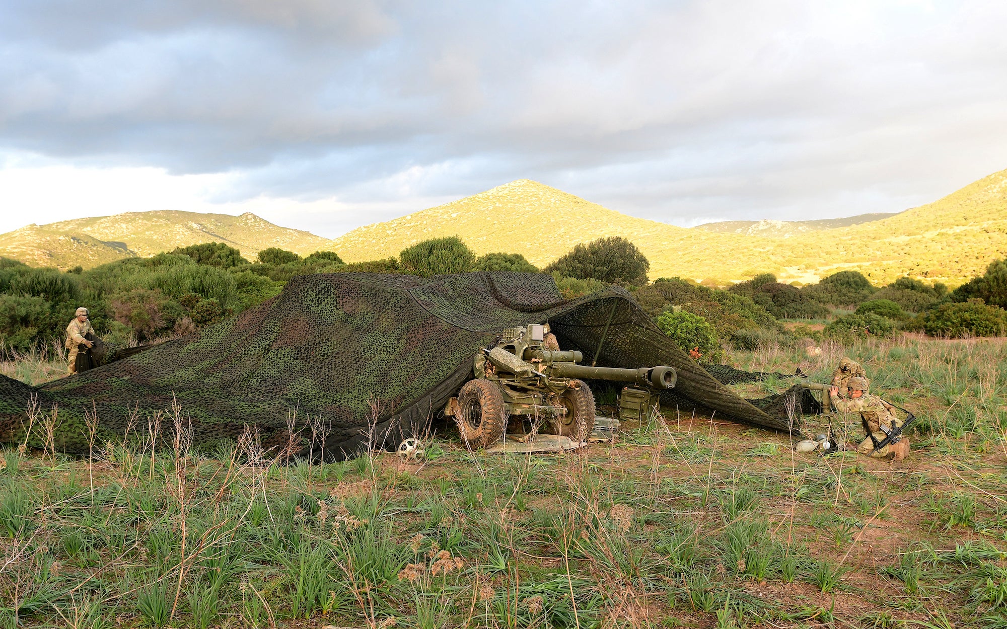 military equipment under camouflage