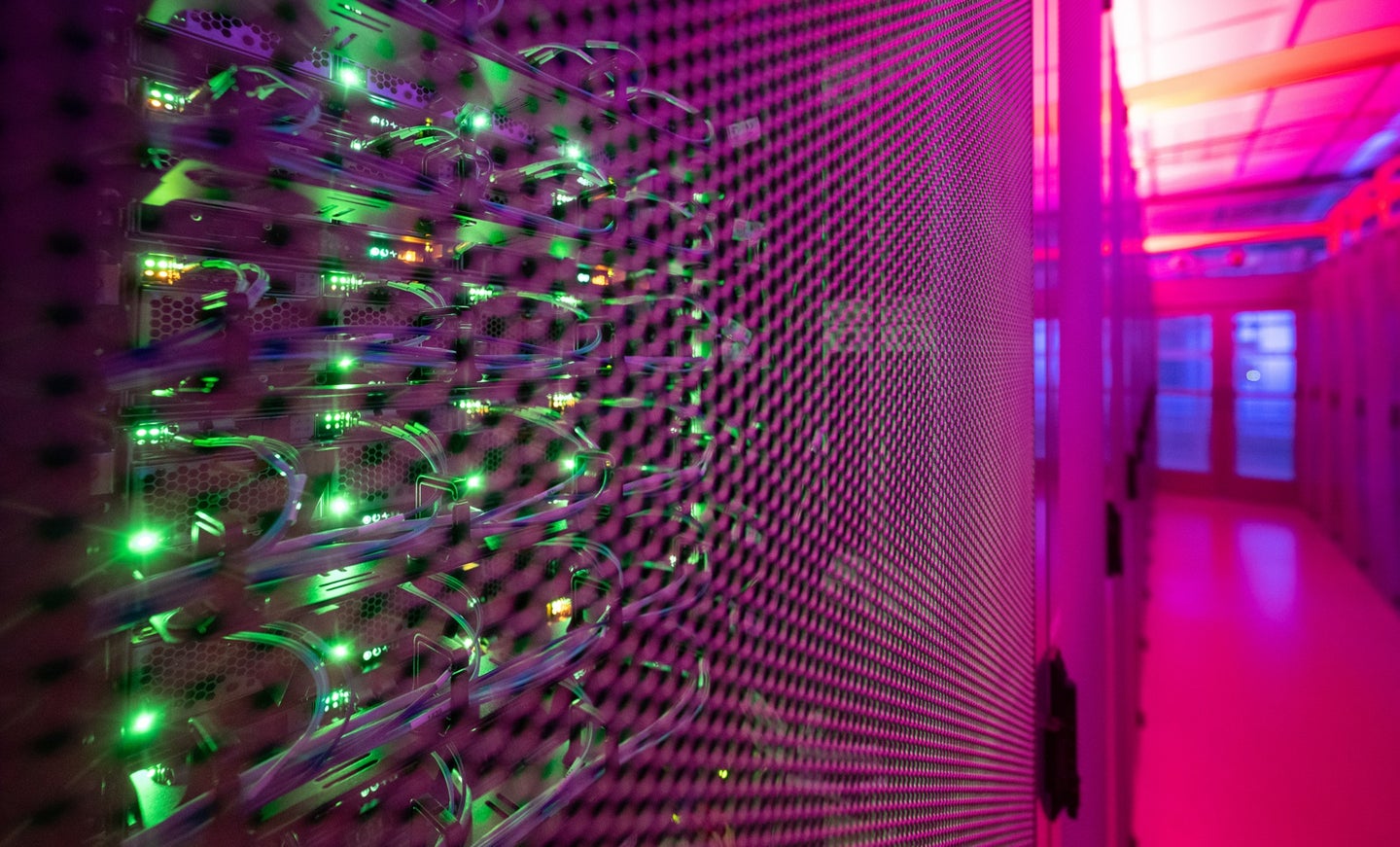 Internet data server farm with green and pink glowing LED lights