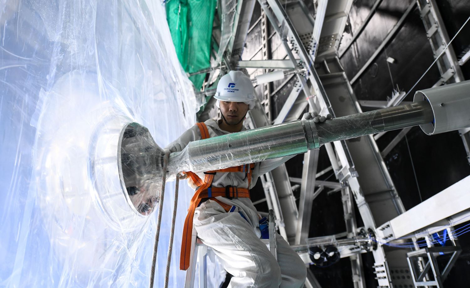 A staff member works at the construction site of the underground neutrino observatory.