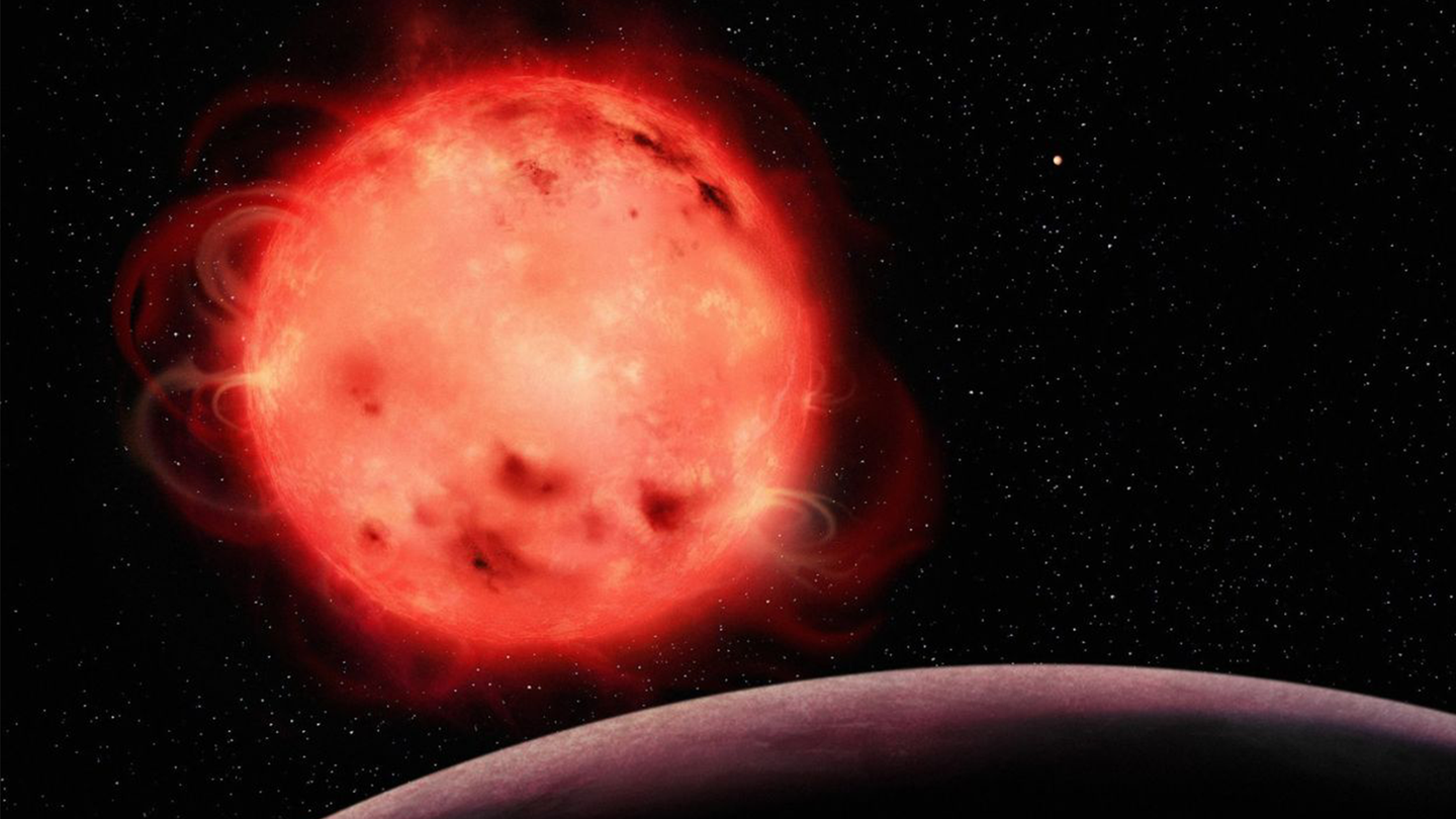 An artistic representation of the TRAPPIST-1 red dwarf star, featuring its very active nature. Exoplanet TRAPPIST-1 b is the closest planet to the system’s central star and is featured in the foreground with no apparent atmosphere. The exoplanet TRAPPIST-1 g is in the background to the right of the star.