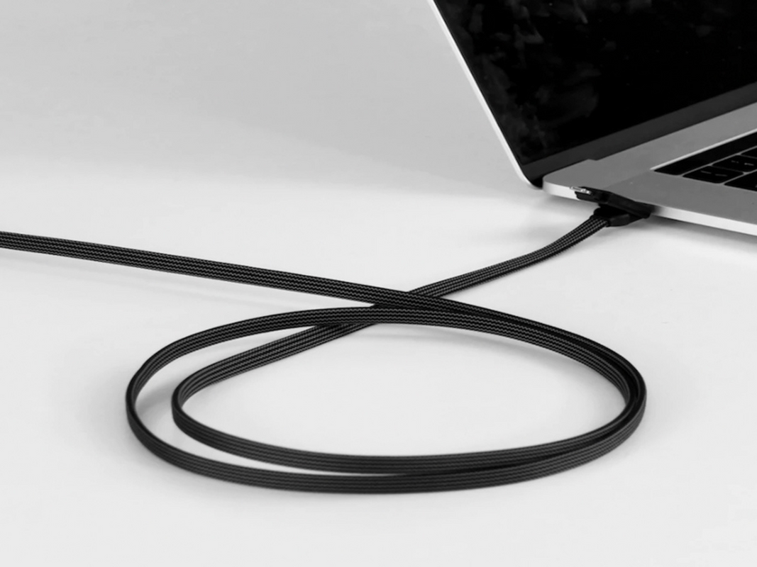 A multi-use charging cable charging a laptop.