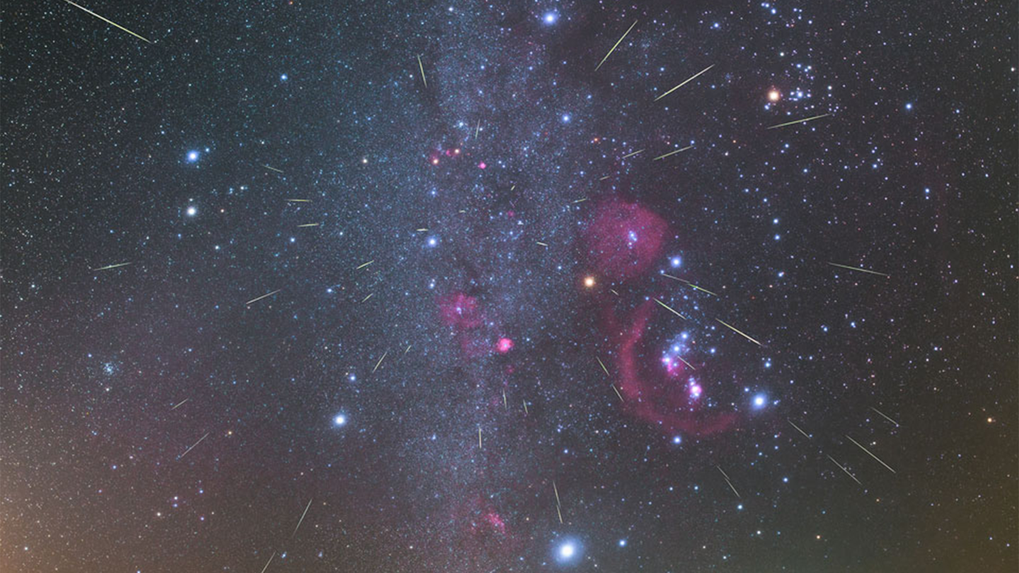 Purple, blue, and white meteors fall at night during October stargazing