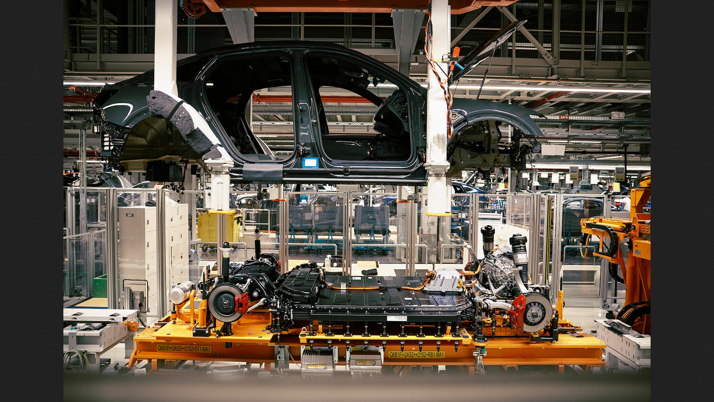 audi car body and battery being assembled in the factory