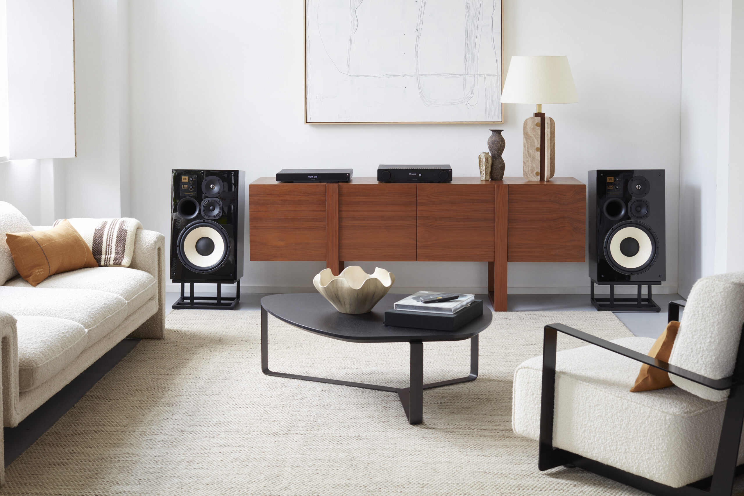The ARCAM A25 integrated amplifier and ST5 high-resolution streamer on a credenza between JBL L100 speakers