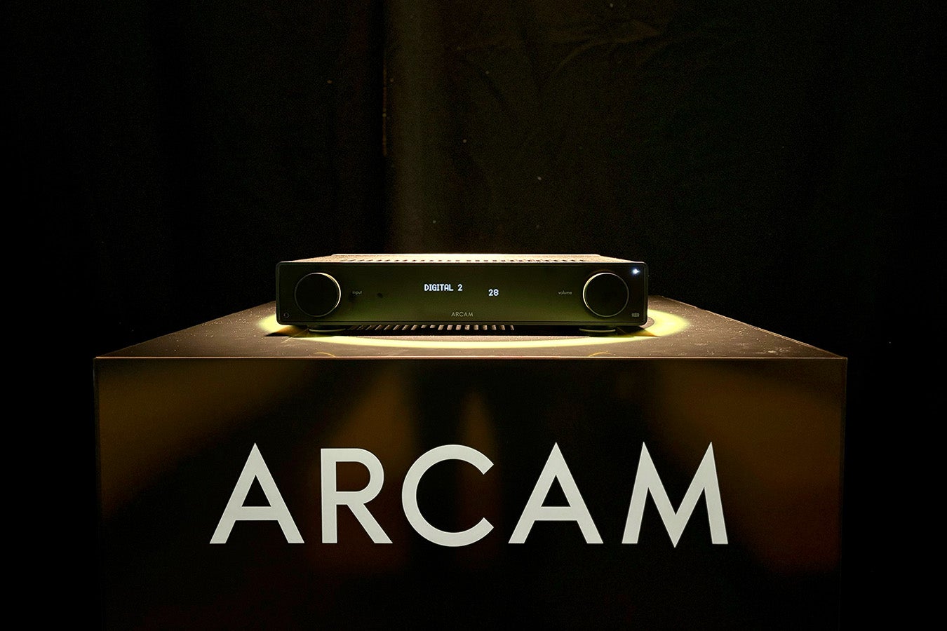 ARCAM A25 integrated amp on a pedestal within a yellow halo