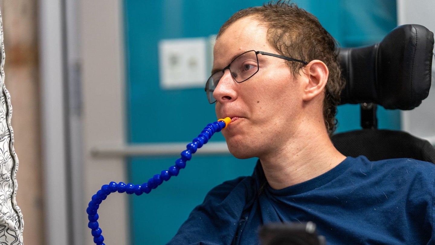 Man with cerebral palsy drinking from RoboCup