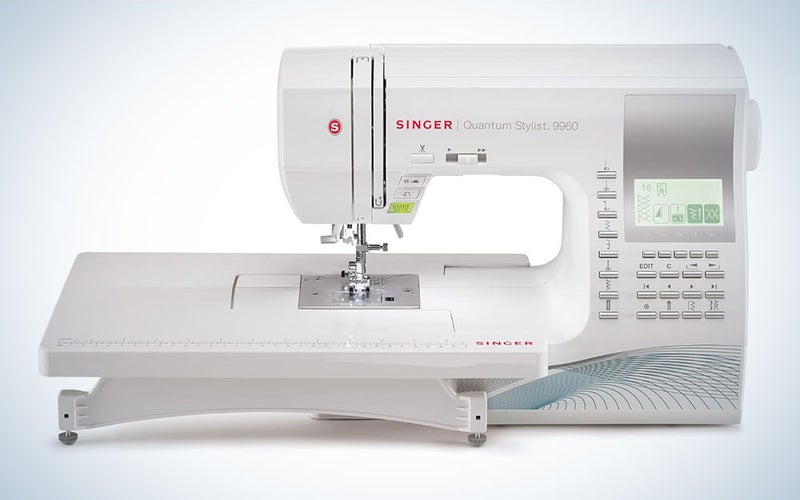 A Singer 9960 Sewing and Quilting Machine on a blue and white background