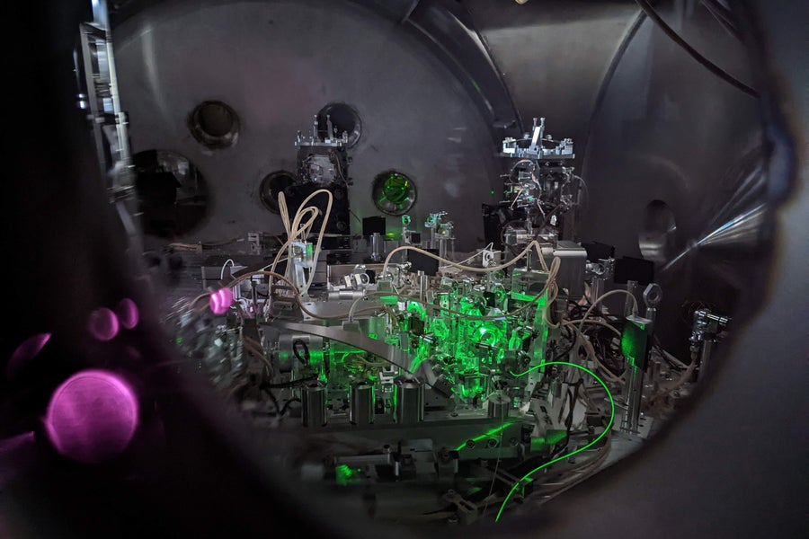 Green light shines on a complex device used to reduce quantum noise.