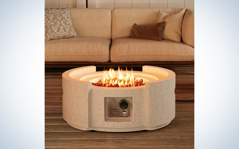 COSIEST Outdoor Propane Fire Pit Table in a living room with a peach couch