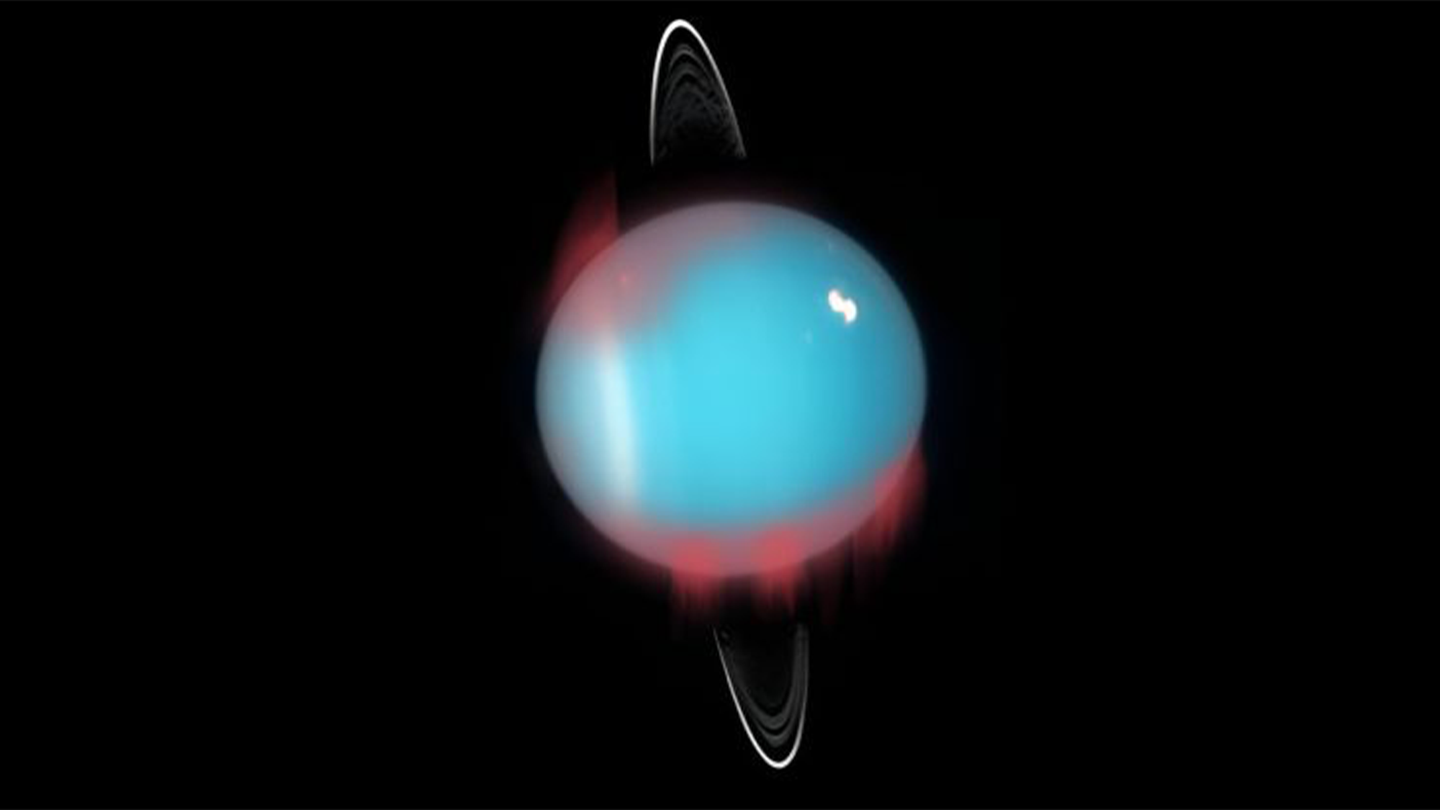 An artist's rendition of the infrared aurora superimposed on a Hubble Space Telescope photograph of Uranus. The planet is blue with a white ring around it and the aurora is shown in red at its poles.