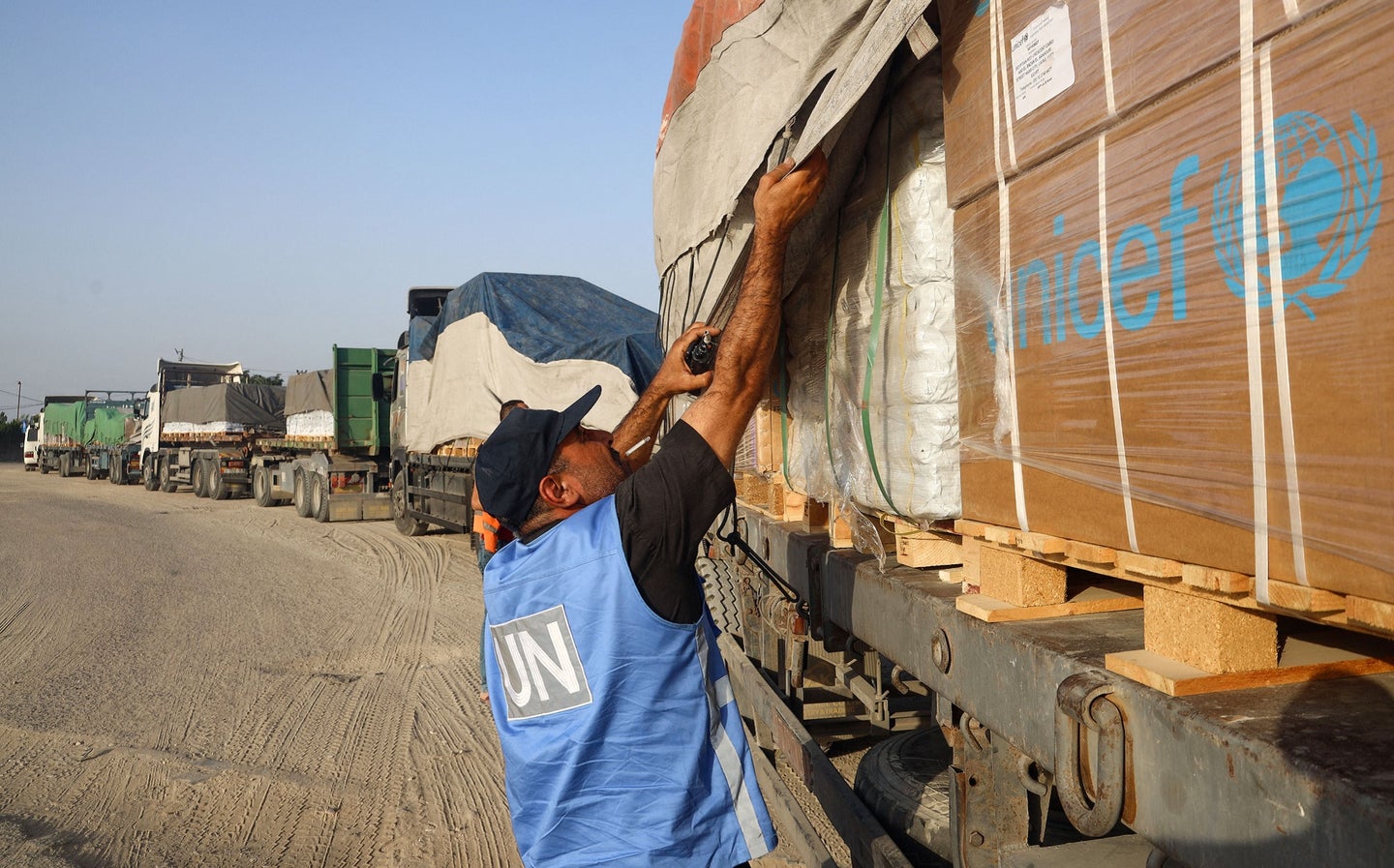 UN worker checking humanitarian aid trucks crossing into the Gaza Strip