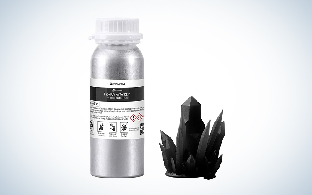silver Monoprice Rapid 3D Printer Resin bottle with a black crystalline structure next to it
