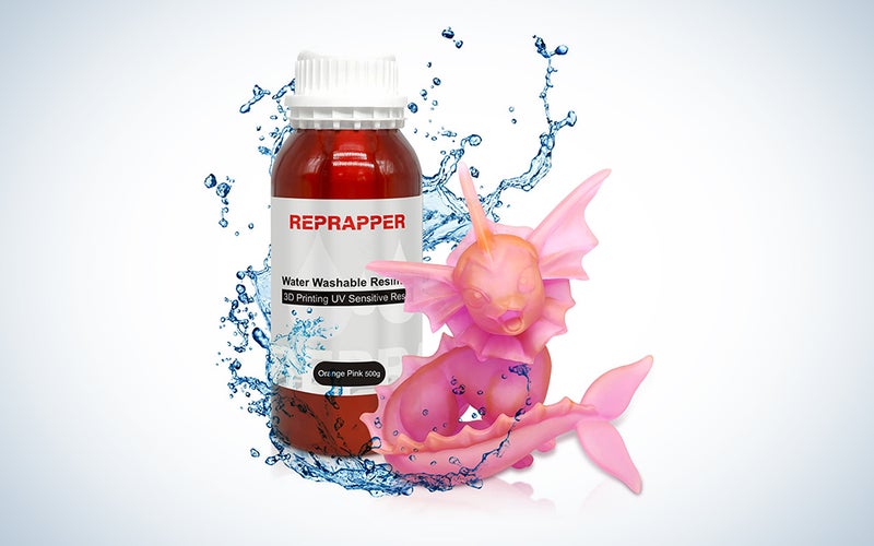 red RepRapper UV Dual Color 3D Resin bottle with a pink figure in front over a white background