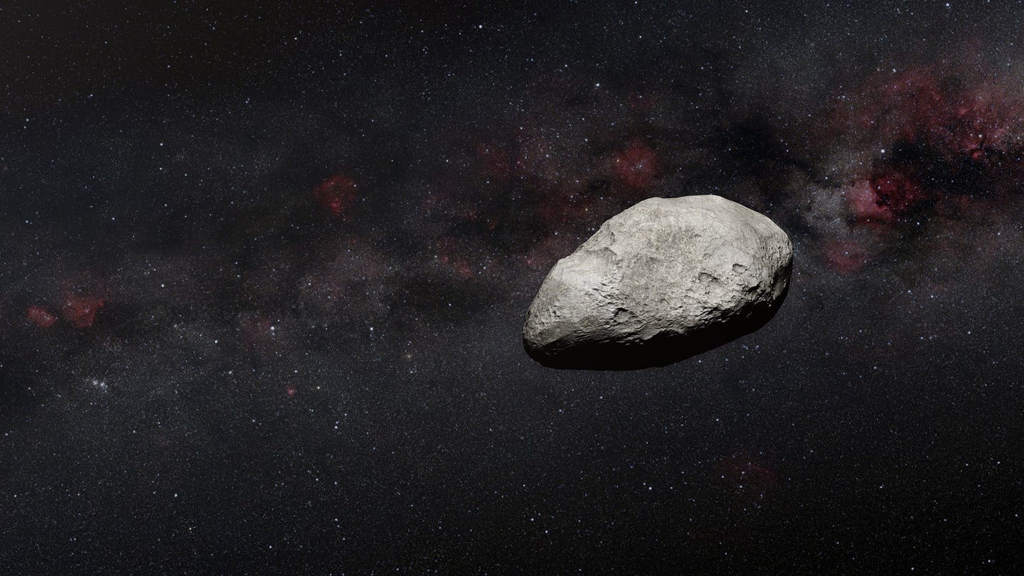 A gray asteroid against the black background of our solar system.