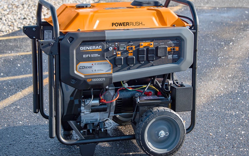 Orange and grey Generac 18000EFI portable generator on wheels in a parking lot