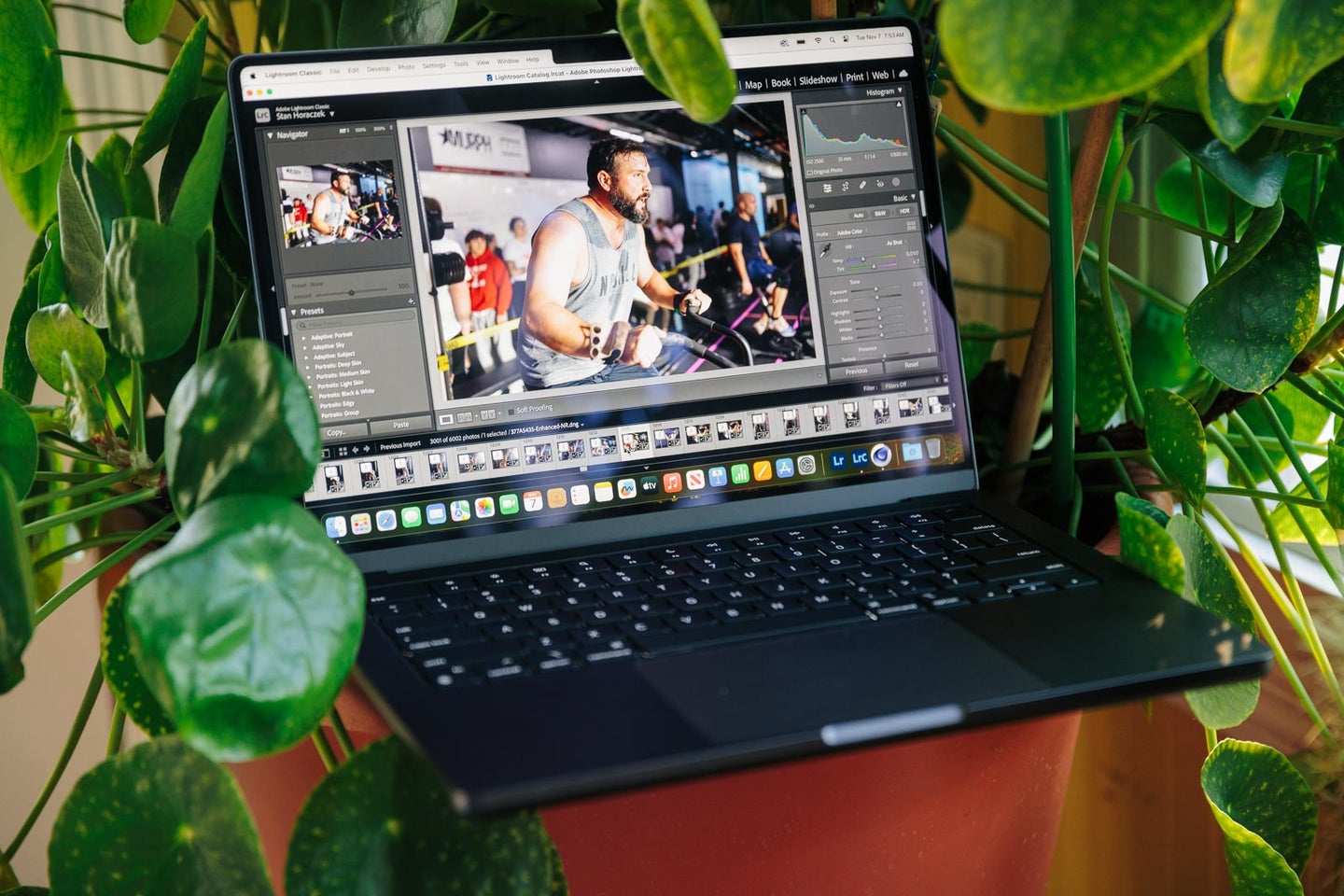 The MacBook Pro 14-inch M3 Max in a plant with Adobe Lightroom on the screen