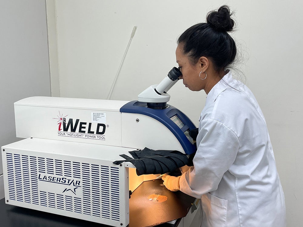 Arah Narida, a graduate student at National Sun Yat-sen University in Taiwan, thaws a cryopreserved hood coral larva with a high-powered laser. In a recent experiment, Narida noticed that larvae collected in the fall seemed more resilient to being frozen and thawed—perhaps because they had already begun adjusting to colder temperatures in the wild. Photo courtesy of Arah Narida