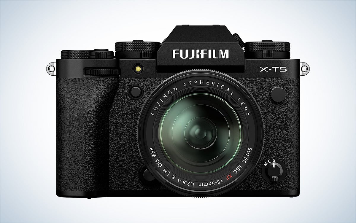 The Fujifilm X-T5 mirrorless camera is placed against a white background with a gray gradient.
