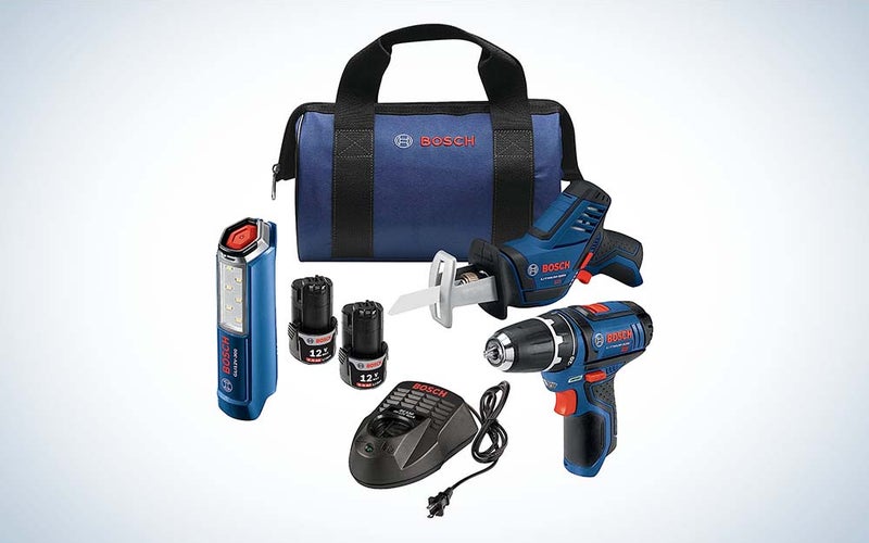 A blue Bosch bag with a set of tools in the foreground, including a drill/driver, LED worklight, Pocket reciprocating saw, and an LED worklight.