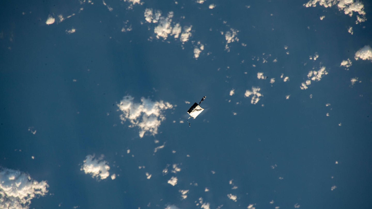 NASA ISS toolbag floating away above Earth