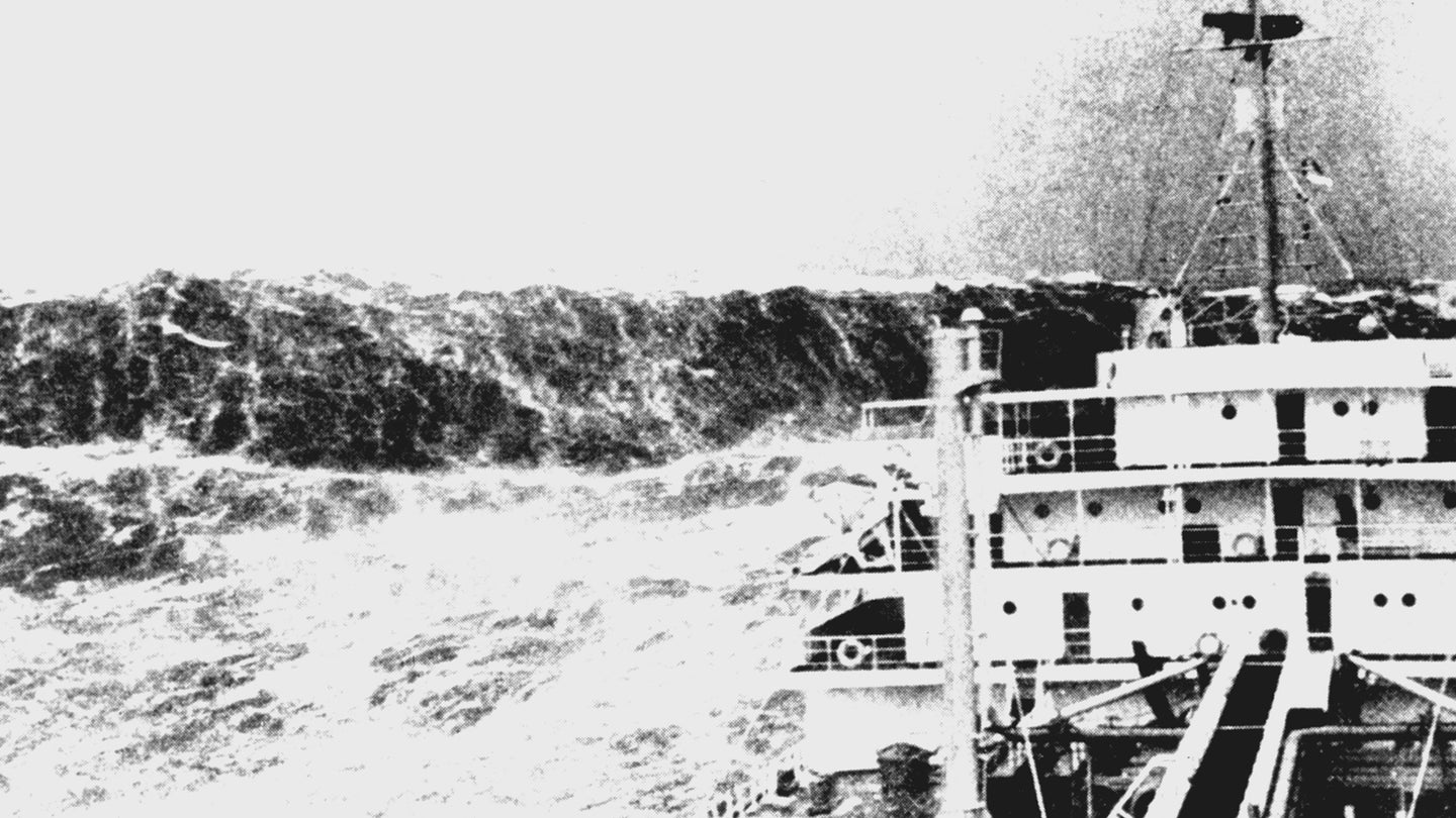 Black and white photo of merchant ship encountering rogue wave